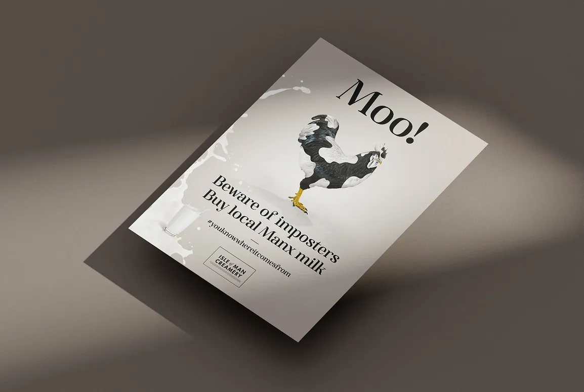 An angled print poster mockup for Isle of Man Creamery on a grey background. The poster features a rooster beside the large headline "Moo!" with a milk splash graphic, the text "Beware of imposters, Buy local Manx milk," the hashtag #youknowwhereitcomesfrom, and the Isle of Man Creamery logo in the bottom left corner.